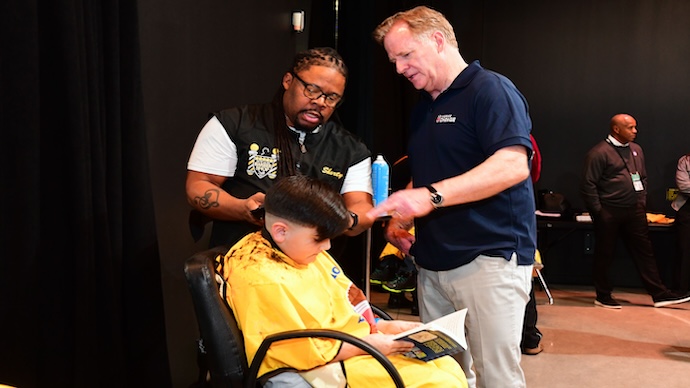 NFL Commissioner Roger Goodell Surprises Kids At Barbershop Books Kickoff Event
